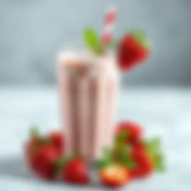 A vibrant strawberry milkshake adorned with fresh strawberries and mint leaves.