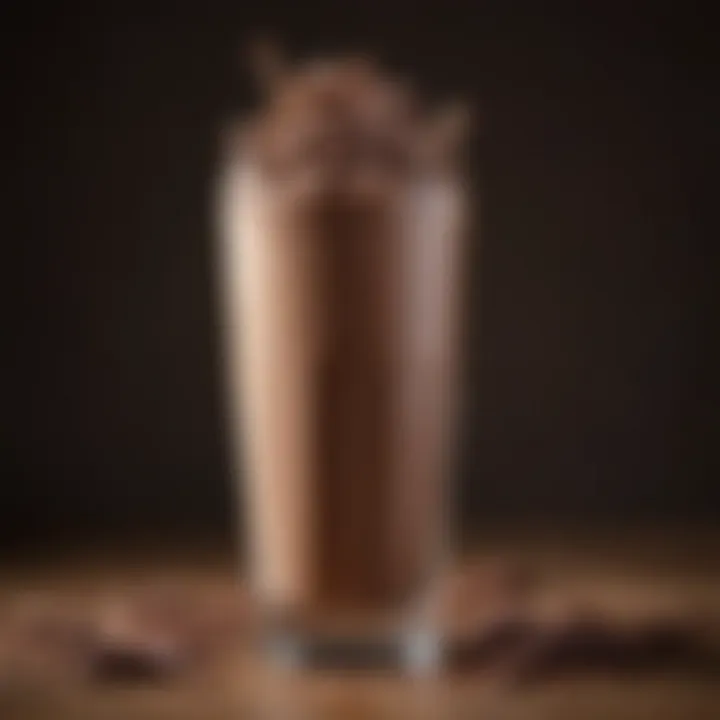A beautifully presented chocolate milkshake in a tall glass with chocolate shavings