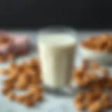 Almond milk in a glass surrounded by almonds