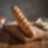 A beautifully shaped baguette resting on a wooden board