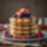 Stack of fluffy three-ingredient pancakes topped with fresh berries and maple syrup