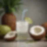 A refreshing coconut water drink in a glass surrounded by fresh coconuts