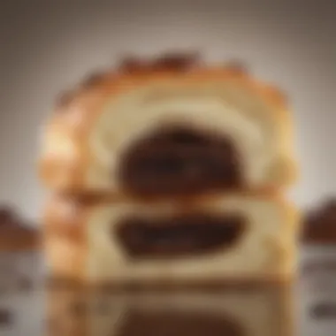 Close-up of flaky layers of pain au chocolat revealing rich chocolate center