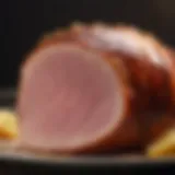 Close-up of a beautifully glazed ham with a shiny surface reflecting light