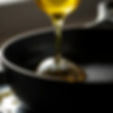 Close-up of oil being applied to a skillet surface