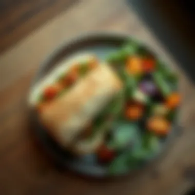 Overhead View with Side Salad An overhead shot of the Mediterranean Veggie Sandwich next to a fresh side salad, highlighting its colorful ingredients.