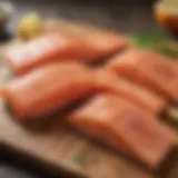 Fresh salmon fillets displayed on a wooden board.