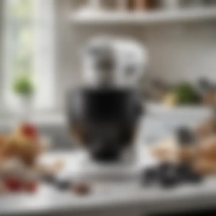 White Kitchen Aid mixer with black bowl on a countertop surrounded by various culinary tools