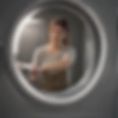 A person checking a dryer drum for items